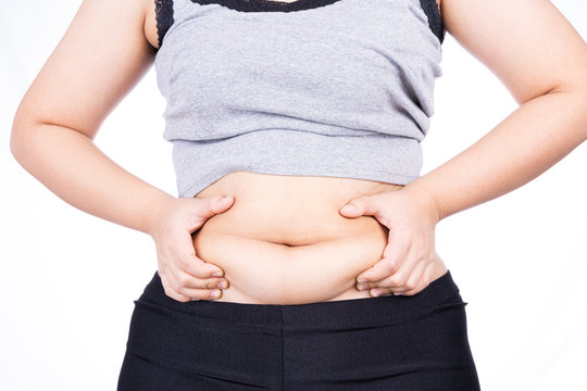 Fat woman holding excessive fat belly, overweight fatty belly isolated on over white background. Diet lifestyle, weight loss, stomach muscle, healthy concept.