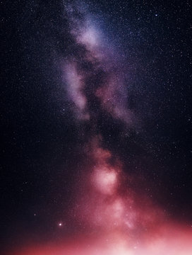 The galaxy is the Milky Way in a rich night sky. A bright summer night scene with a starry sky.