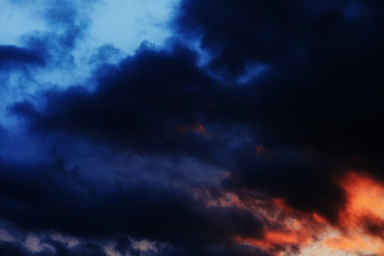 Beautiful gloomy sunset sky in blue and red tones