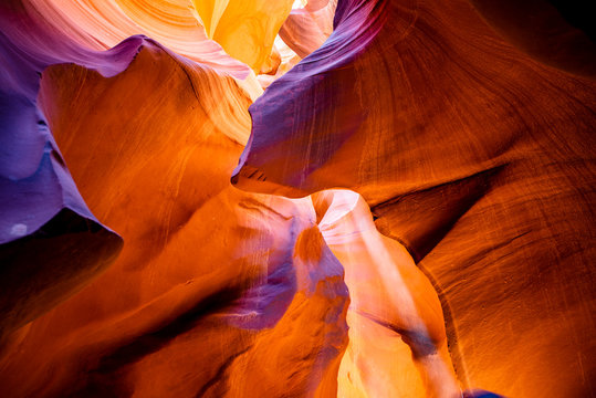 An attractive natural landscape for tourists in the Lower Antelope Canyon in Page Arizona with bright sandstones stacked in flaky fire waves in a narrow sandy labyrinth with caves