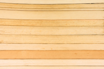 Fototapeta premium Old and well used hardback books or text books on a shelf book or library. Many Books Piles.