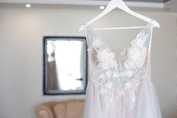 Luxury Lace Wedding Dress Hanging in room.