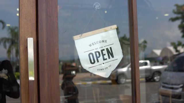 Vintage style coffee shop opening sign during the day