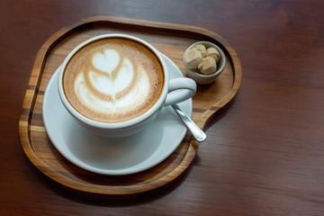 Cup of coffee on wooden tray with sweets. Breakfast time.