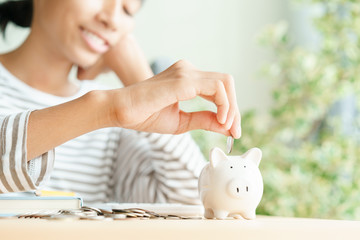  Happy Asian woman saving money in piggy bank For future scholarships