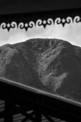 Black and white photograph of a mountain peak within a frame