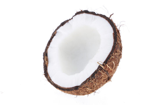 Fresh raw coconut with palm leaves isolated on white background. High resolution image