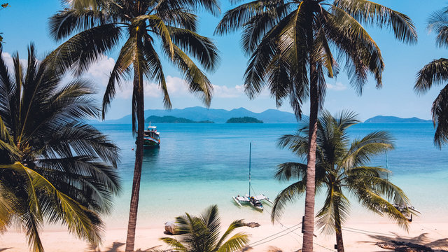 Clear water on the island,Bright blue sea and wooden boat The tourism