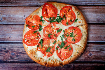 classic Italian pizza on a wooden table top view