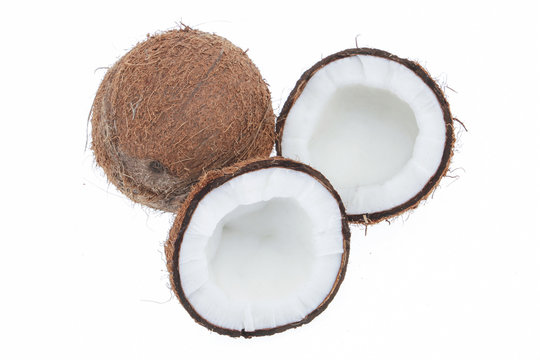 Fresh raw coconut with palm leaves isolated on white background. High resolution image