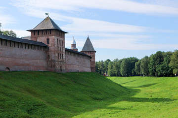 Fototapeta na wymiar View to the wall and towers of the Velikiy (Great) Novgorod citadel (kremlin, detinets) in Russia under blue summer sky in the morning 