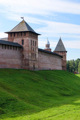 Fototapeta premium View to the wall and towers of the Velikiy (Great) Novgorod citadel (kremlin, detinets) in Russia under blue summer sky in the morning 