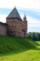 Fototapeta na wymiar View to the wall and towers of the Velikiy (Great) Novgorod citadel (kremlin, detinets) in Russia under blue summer sky in the morning 