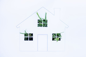 Top view of drawn house with green grass on white background, ecology concept