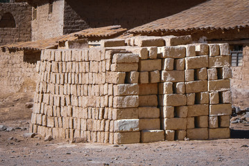 Stack of sun dried adobe bricks ready to use for building a house, Peru, South America