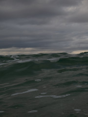 Small waves breaking on a surf beach, New Zealand. 