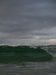 Small waves breaking on a surf beach, New Zealand. 