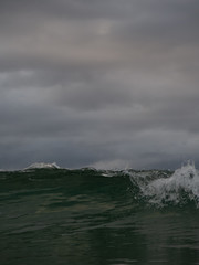 Small waves breaking on a surf beach, New Zealand. 