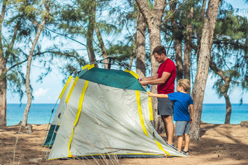 Camping people outdoor lifestyle tourists put up set up green grey campsite summer forest near...