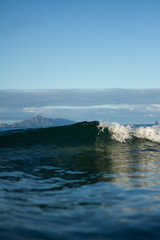 Small waves breaking on a surf beach, New Zealand. 