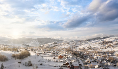 Fototapeta na wymiar Beautiful village in a mountain winter landscape