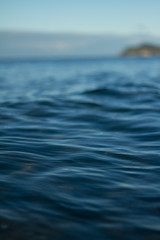 Small waves breaking on a surf beach, New Zealand. 