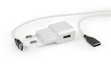 Fototapeta premium Mobile devices charger and appropriate cable on a white background
