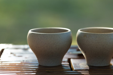 Ceramic bowls made of clay on a wooden background.