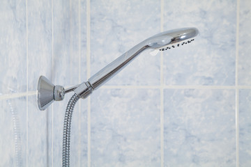 Water shower with blue wall tiles. Bathroom
