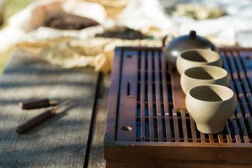Chinese tea ceremony. Ceramic teapot made of clay and bowls on a wooden background.