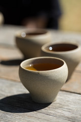 Ceramic bowls made of clay on a wooden background.