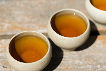 Ceramic bowls made of clay on a wooden background.