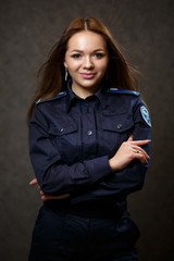 portrait of a beautiful girl in police uniform. Professional posing
