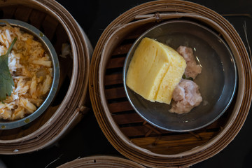 Sweet egg and Dim Sum in bamboo basket.