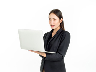 Asian smiling business women wearing suit using laptop computer isolated on white background.