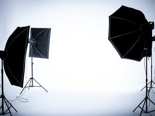Empty white background in photography studio interior with lighting set up.