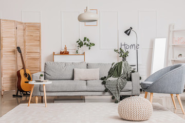 Stylish interior of living room with comfortable furniture