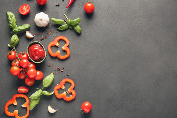 Naklejka na ściany i meble Composition with fresh cherry tomatoes, sauce and spices on grey background