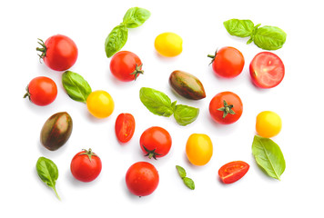 Fresh cherry tomatoes and basil on white background