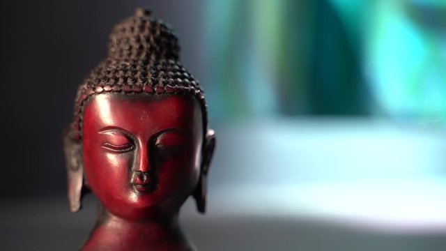 buddha red Idol face mediating with indoor dark background