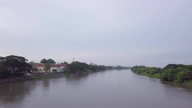 Aerial drone shot flying over the Magdalena River in Mompos, Colombia.