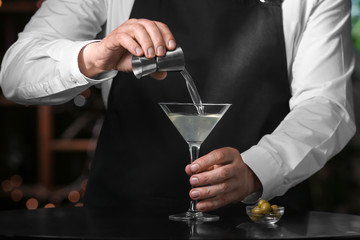 Bartender making fresh martini in pub