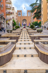 Cosenza, Italy - May 7, 2018: View of modern stairs street via Arabia with fountains, multicolored buildings and church of Parrocchia Teresa del Bambino Gesu, Calabria