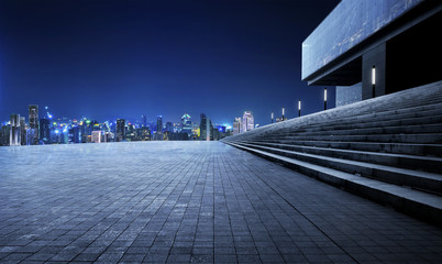 Rooftop empty brick floor and night city skyline