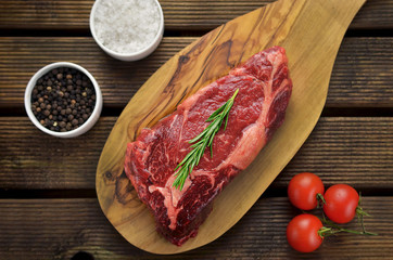 Raw entrecote steak on cutting board