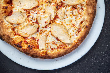 pizza on the black background, top view