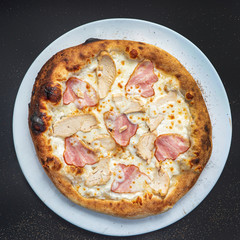 pizza on the black background, top view