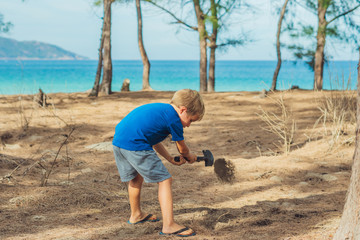 Camping people outdoor lifestyle tourists, summer forest near lazur sea. Blond boy play study...