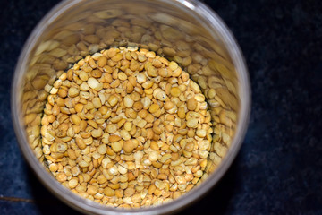 Split pulses in huge number kept in a bottle which gives the reflection of yellow pulses