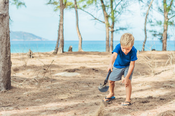 Camping people outdoor lifestyle tourists, summer forest near lazur sea. Blond boy play study...